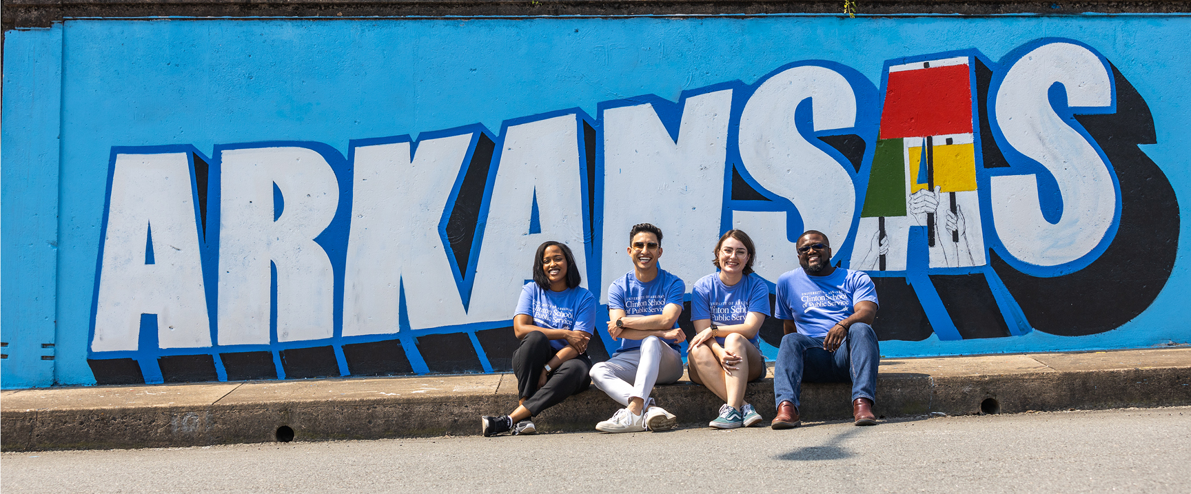 Clinton School students in front of Arkansas mural